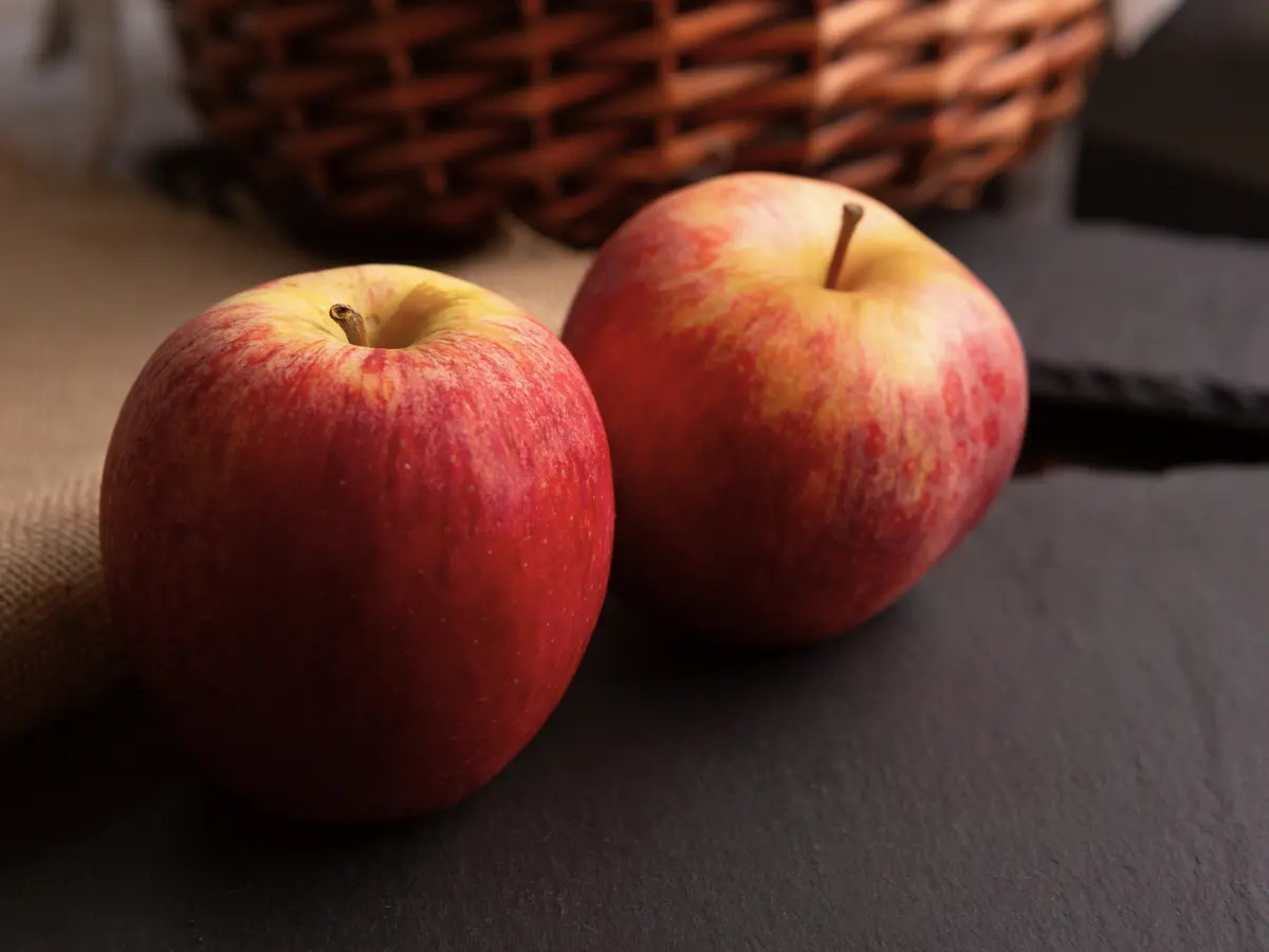 Apples on a slate plate. Two red apples on a slate plate.
