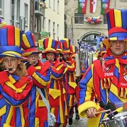 Marching band in red, yellow and blue uniforms at Karneval in Köln (Cologne), drummers leading the parade