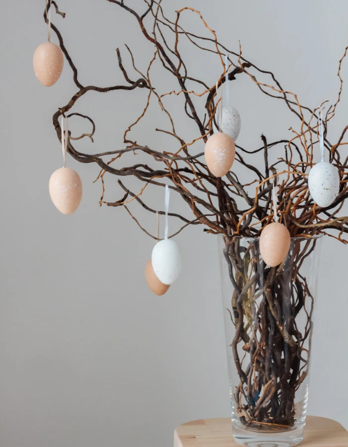 A German Easter egg tree (Osterbaum) hung with pastel eggs in a glass vase, a German family tradition started at home outside of Germany.
