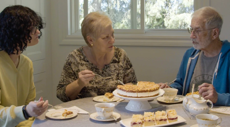Family gathered around a Kaffee und Kuchen table, the small German afternoon ritual that does most of the actual work.