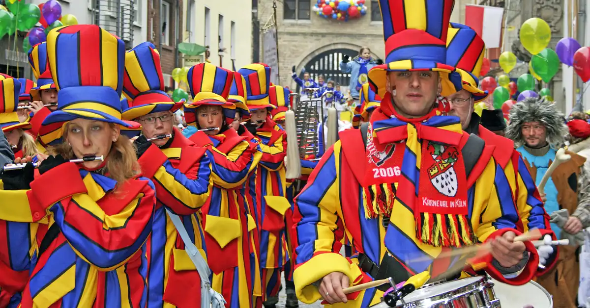 Marching band in red, yellow and blue uniforms at Karneval in Köln (Cologne), drummers leading the parade