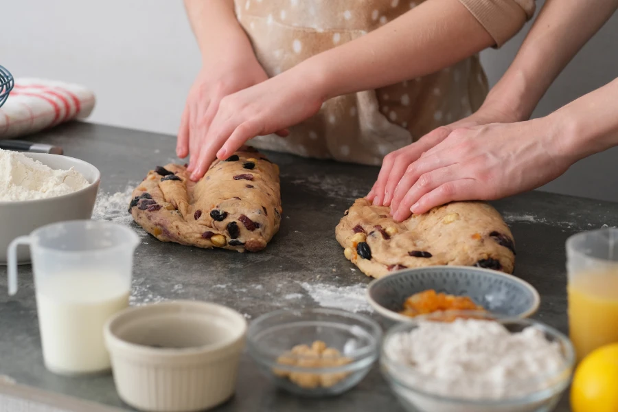 A child and an adult kneading Stollen dough together, the repeated kitchen ritual the research actually rewards.