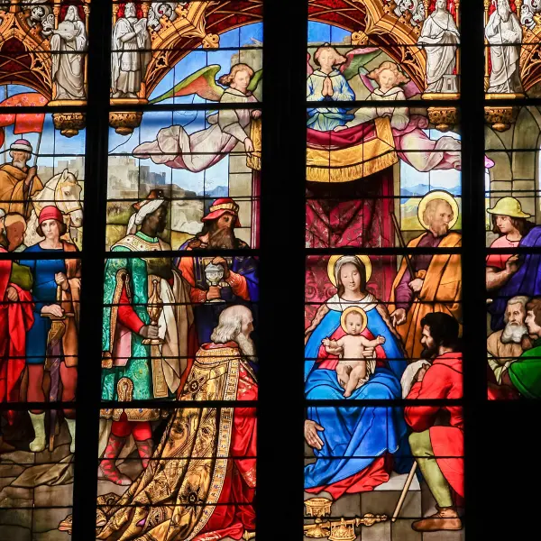 Colourful stained-glass depiction of the magi at the birth of Jesus in the Cologne Cathedral