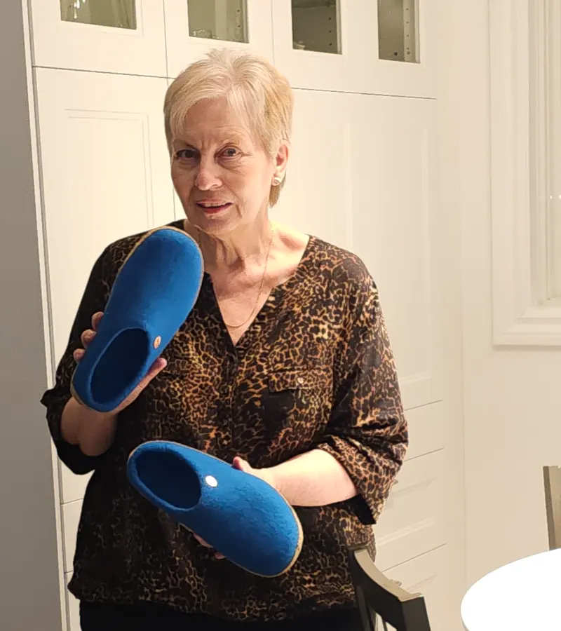 Oma holding blue house shoes (hausschuhe)
