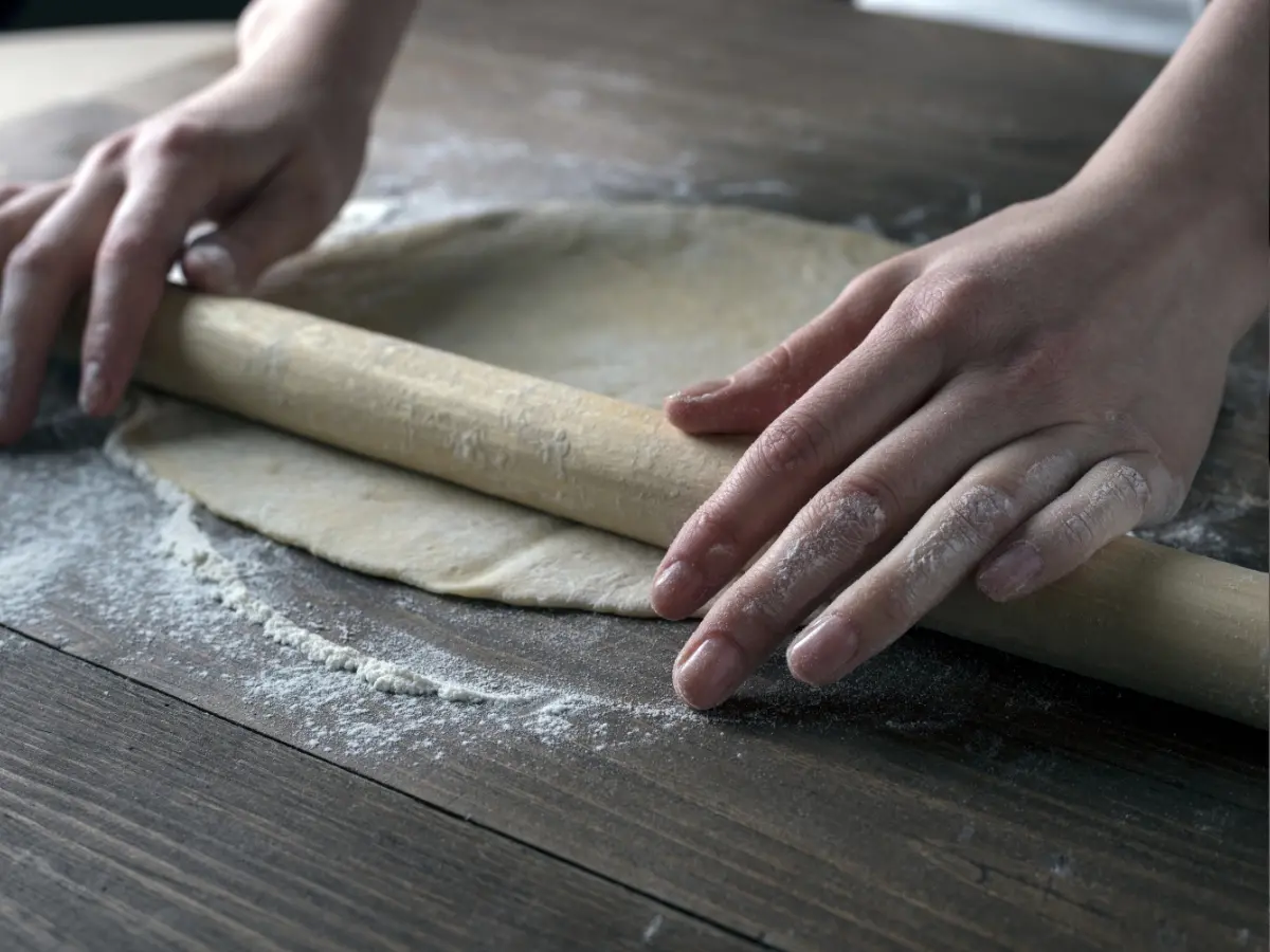 Rolling out dough. dough being rolled out with a rolling pin.