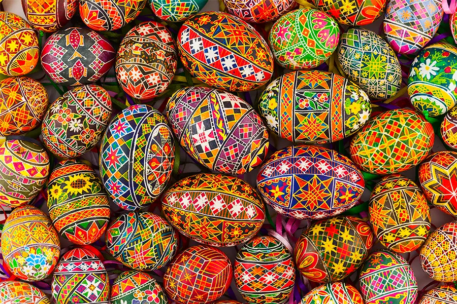 A collection of intricately painted Easter eggs with various colorful patterns and designs.