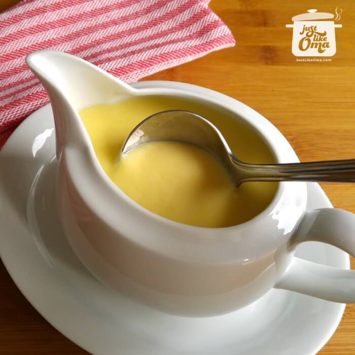 Vanilla sauce in a jug with ladle.