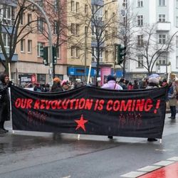Protesters hold a banner reading “OUR REVOLUTION IS COMING!” during a March 8 International Women’s Day rally in Germany.