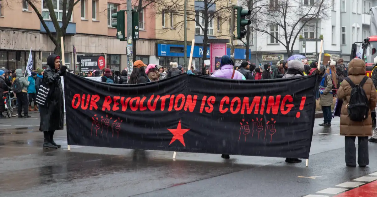 Protesters hold a banner reading “OUR REVOLUTION IS COMING!” during a March 8 International Women’s Day rally in Germany.