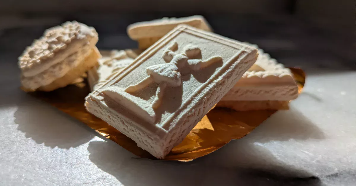 Close-up of traditional Springerle cookies with embossed designs, photographed in natural light.